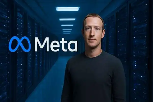 Mark Zuckerberg stands in a futuristic data center with the glowing Meta logo beside him, representing Meta’s expansion into AI and data infrastructure.